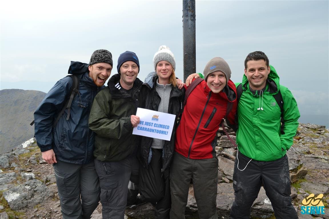 SERVE staff and volunteers on at the top of Carrauntoohil, Kerry while taking part in the SERVE Four Peaks Challenge