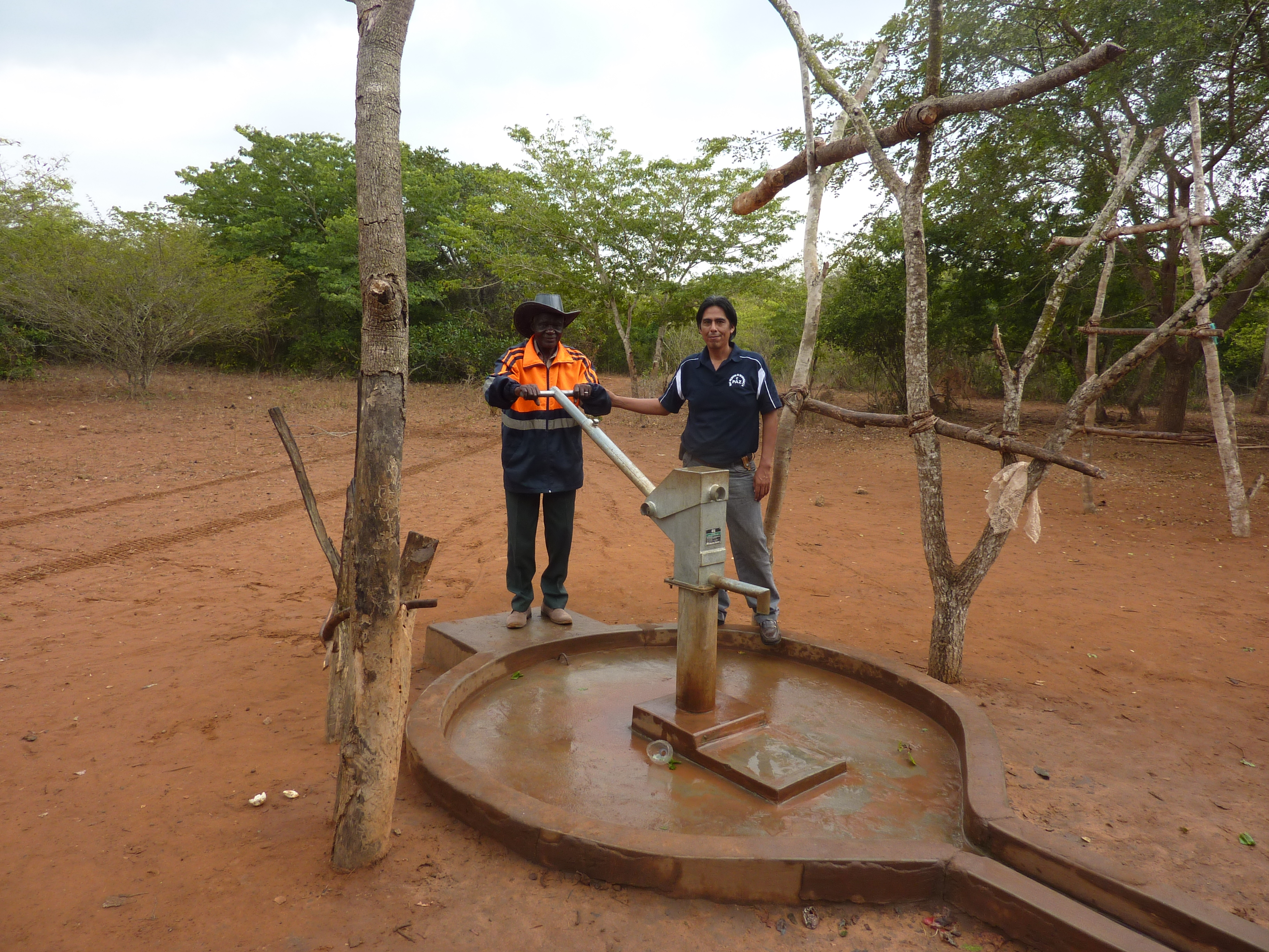 Jose Luis with Community Committee Member at a rehabilitated well in Mavume, Mozambique