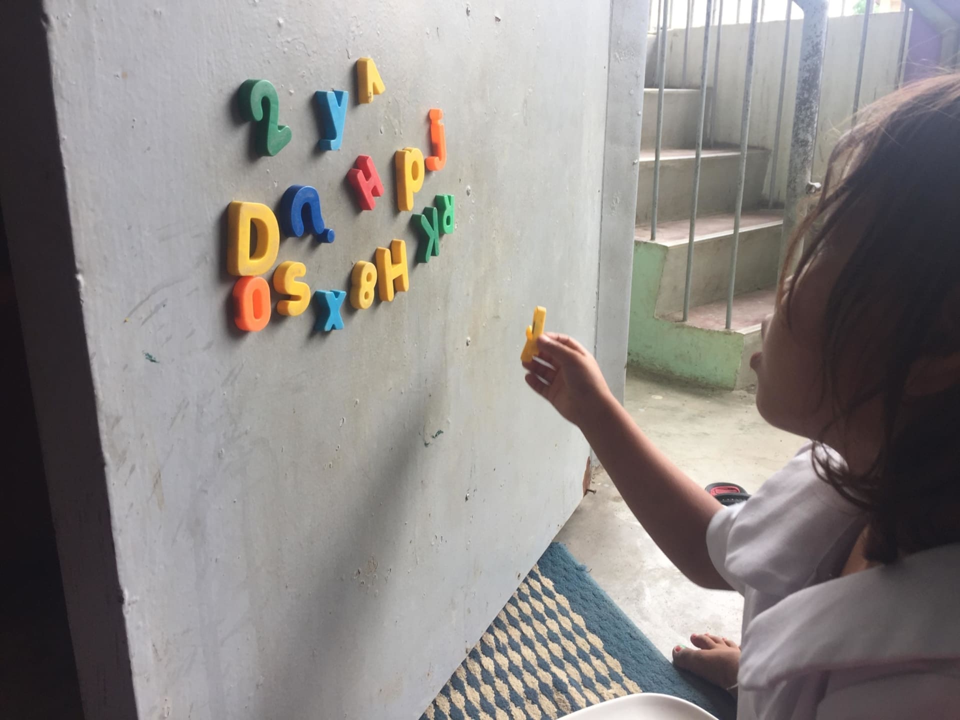 This is a child from the Badjao Montessori class. Magnets are used to improve the children's letter and number-sense. The materials used in the Badjao Montessori class are identical to any Montessori class, in any developed country around the world. Education has become the pride of the Badjao tribe, contrary to the belief that education is not of importance in developing countries and societies, and this is illustrated through each child's participation and enthusiasm in their lessons. Photo: Brónagh Hogan
