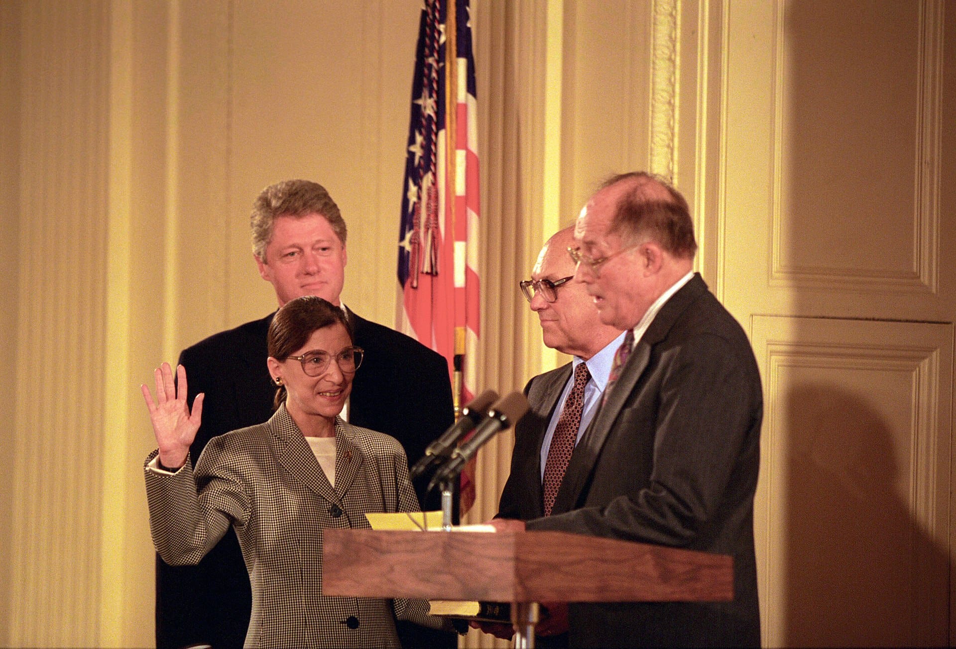 Chief Justice William Rehnquist swearing in Ginsburg as an associate justice of the Supreme Court, as her husband Martin Ginsburg and President Clinton watch.